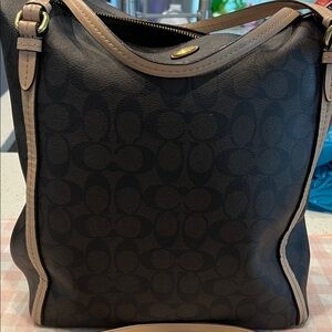 Coach"C"pattern and is accented with vachetta leather trim /handles. a zip-top